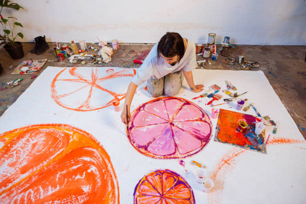 istock Creative young woman painting in her studio 1388629134