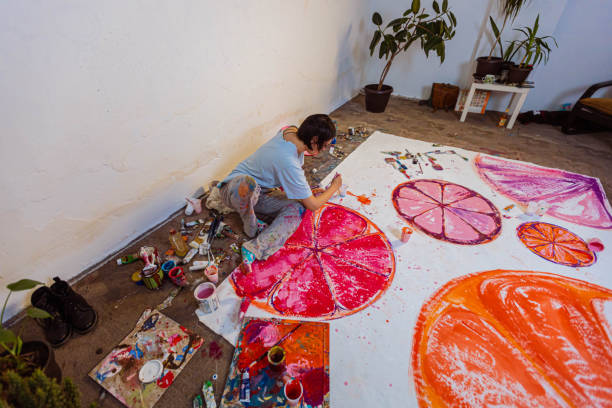istock Female artist making art in the studio 1388629275