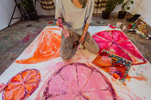 Artist painting oil on canvas in his art studio