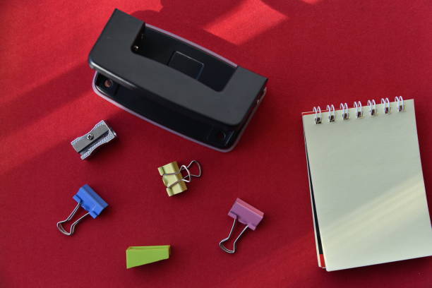 istock Pencils hole punch and notepad on a red background 1388630600