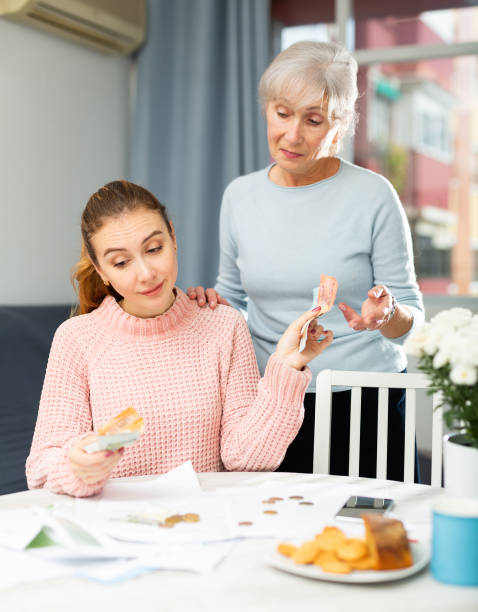 istock Daughter giving money to mother 1388630721