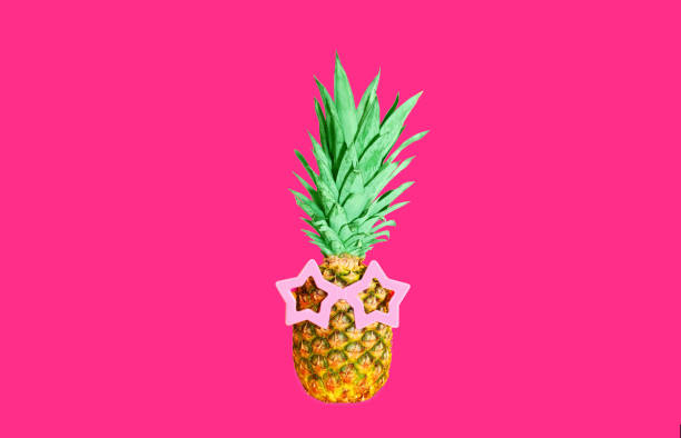 istock Pineapple with pink sunglasses on pink background, colorful ananas 1388630792