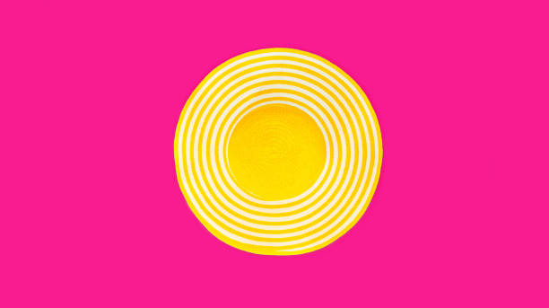istock Summer yellow straw beach hat on colorful pink background, top view 1388630793