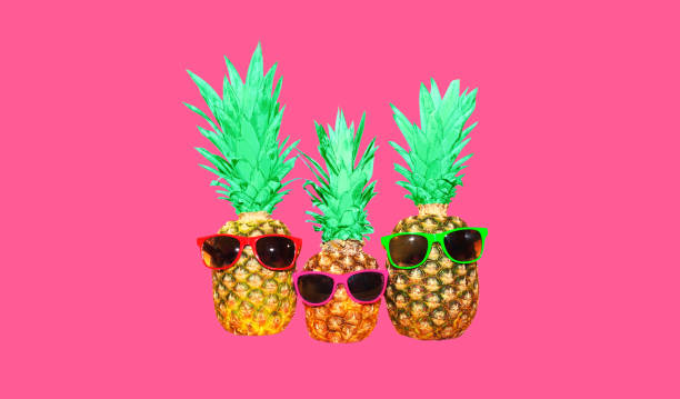 istock Pineapple with pink sunglasses on pink background, colorful ananas 1388630802