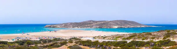 Photo of Prasonisi beach on the southern part of Rhodes, Greece. Famous surfer hotspot between two seas. People ride by  kitesurf and windsurf