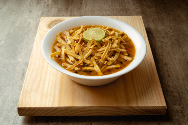istock Traditional mexican lime soup with chicken on a wooden base 1388632106
