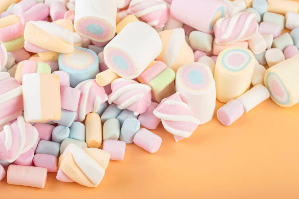 istock Colorful marshmallows on brown background. Delicious dessert. Fluffy marshmallows. 1388634384