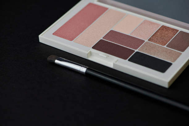 istock palette with eye shadow and rouge on black background 1388634411