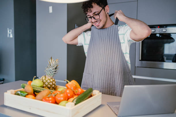 istock Young man preparing to cook and trying new recipes 1388635606