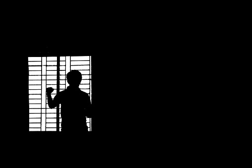 Minimal view of silhouette Standing besides window