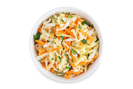 Cabbage carrot salad in a bowl on a white isolated background. toning. selective focus