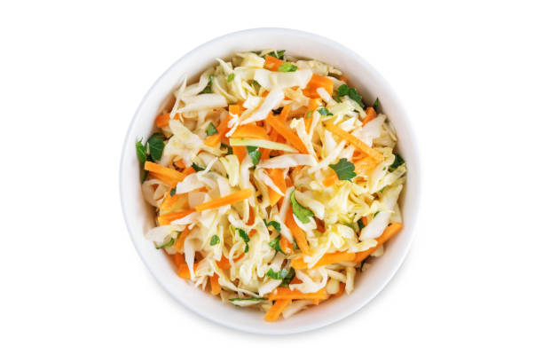 Cabbage carrot salad in a bowl on a white isolated background Cabbage carrot salad in a bowl on a white isolated background. toning. selective focus coleslaw stock pictures, royalty-free photos & images