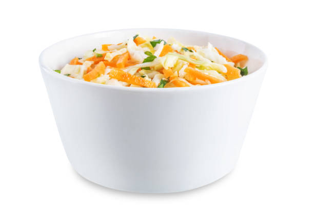istock Cabbage carrot salad in a bowl on a white isolated background 1388636814