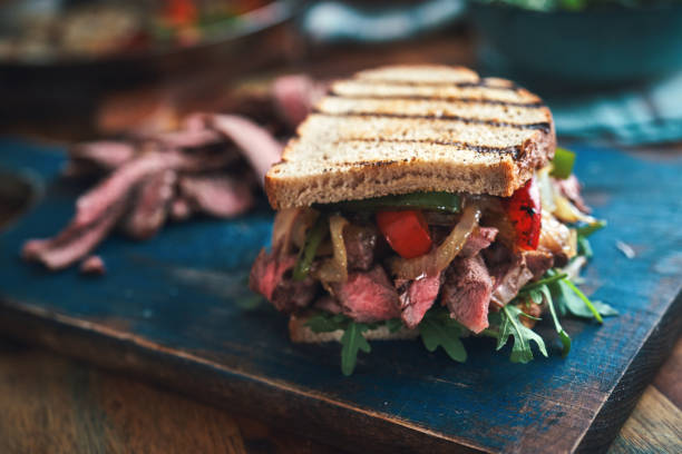 istock Preparing Steak Sandwich with Roasted Bell Pepper and Arugula 1388637474