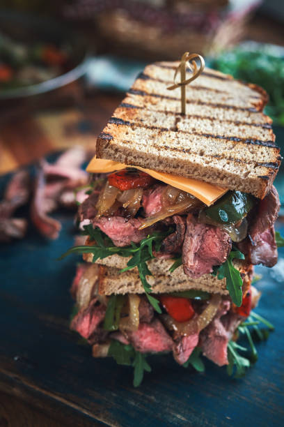 istock Preparing Steak Sandwich with Roasted Bell Pepper and Arugula 1388637512