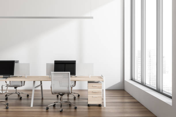 istock Office room interior with seats, table and computers, window with city view 1388639053