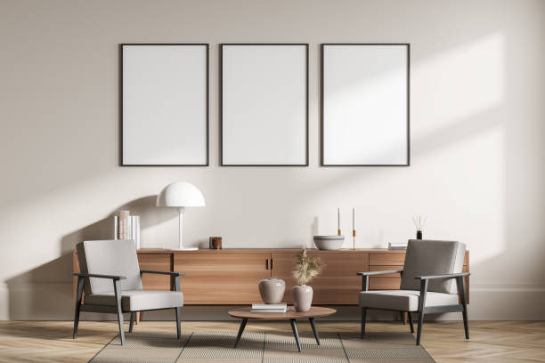 istock Light guest room interior with seats and commode, coffee table and mockup posters 1388640111