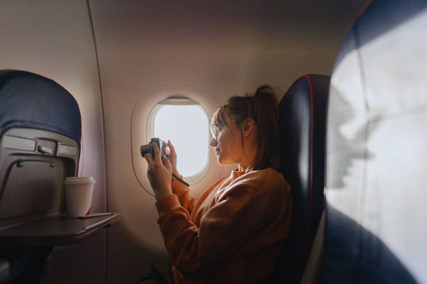 istock Taking photos through the window of the plane 1388641878