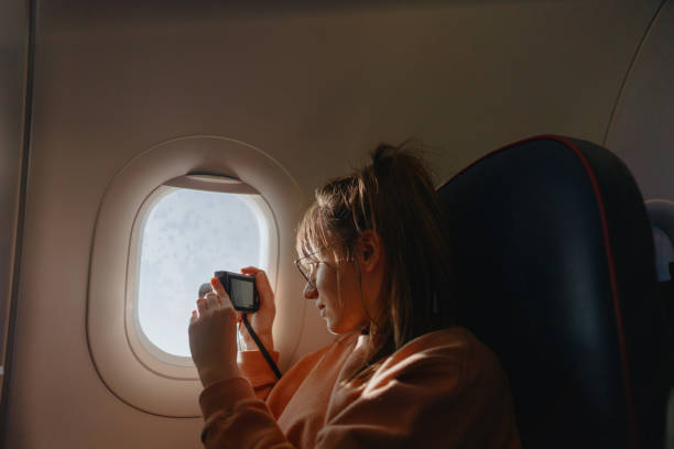 Taking photos through the window of the plane