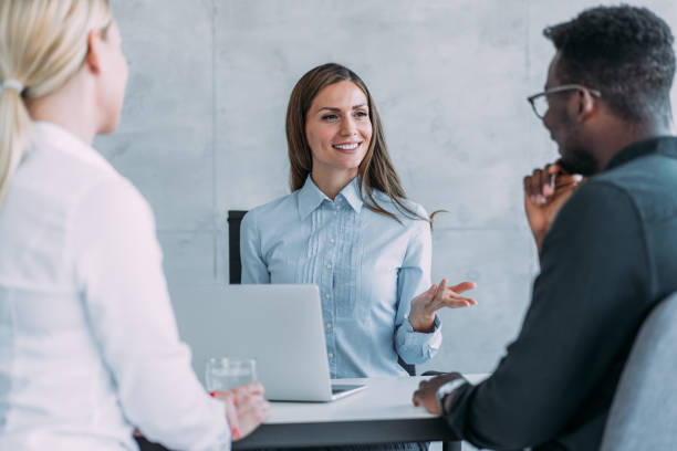 istock Group of business persons talking in the office. 1388642121