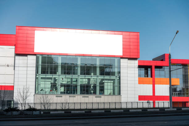 Long horizontal empty vinyl advertising banner located on urban building. Business and marketing at city street concept.