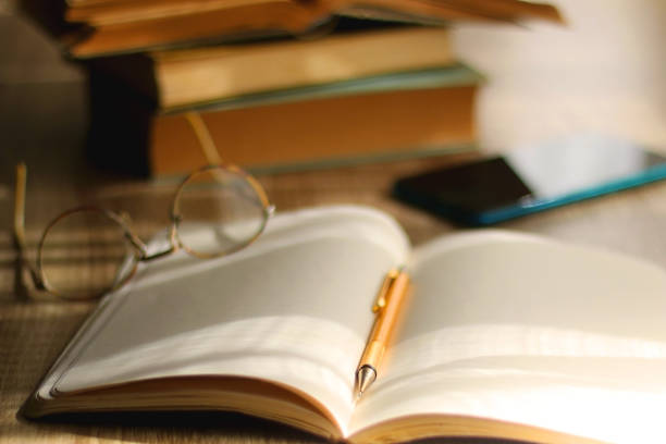 istock Notebook, Pencil, Glasses, Phone and Books 1388642953