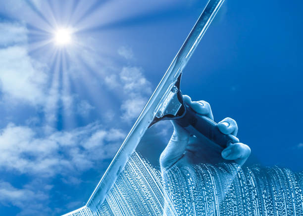 The window cleaner cleans the office windows