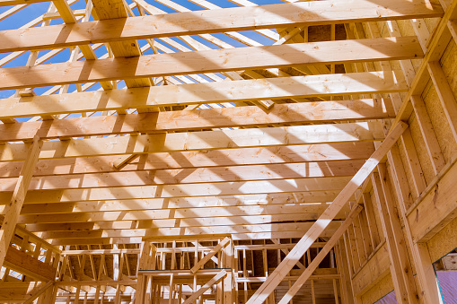 Roof truss system with wooden timber, beams an interior view house building