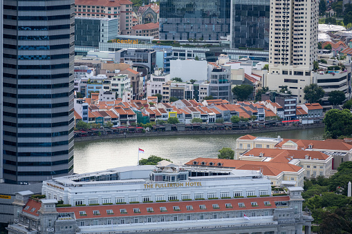 The Boat Quay area in Singapore consists of old buildings now hosting restaurants and bars. The Singapore River is running through this old district which is also surrounded by modern modern skyscraper buildings.