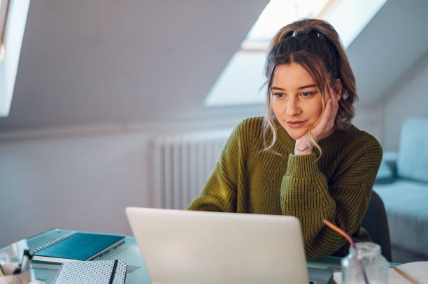 istock Woman working from a home on her a laptop 1388644083