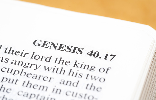 Genesis, the first book of the Old Testament, Holy Bible beginning, world universe origin story, creationism concept, single text line, word line closeup macro detail, nobody