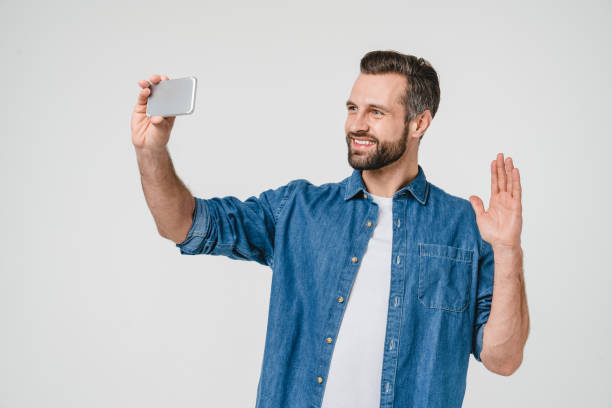istock Videocall conversation conference online. Caucasian young student freelancer man talking on smart phone, blogging vlogging online isolated in white background 1388644897