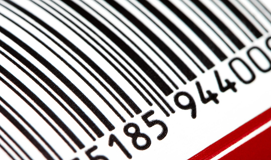 Part of a barcode on a simple drink tin can, bar code tag label object rolling in, detail, macro, extreme closeup, nobody. Food products origin, retail business and consumerism abstract concept