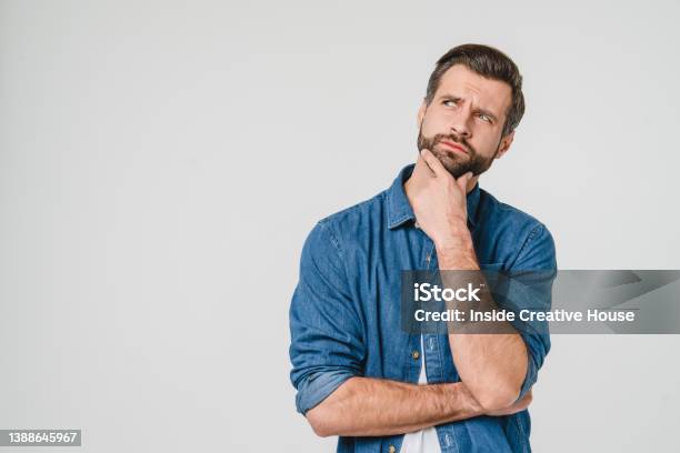 Pensive Thoughtful Contemplating Caucasian Young Man Thinking About Future Planning New Startup Looking Upwards Isolated In White Background Stock Photo - Download Image Now