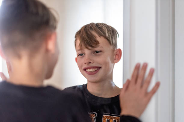 istock Portrait smiling boy in the mirror 1388647072