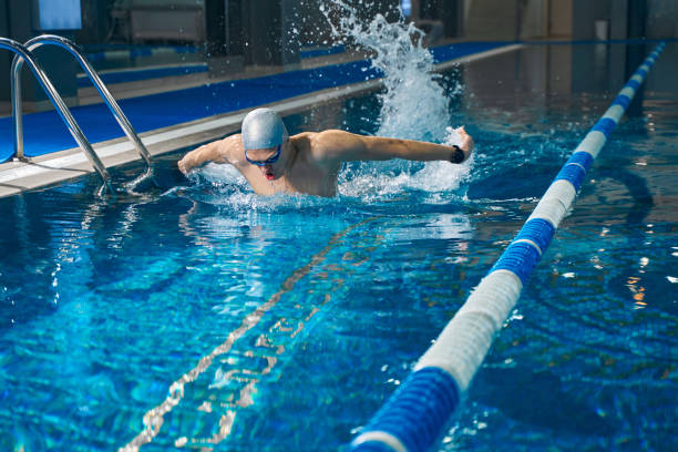 istock Sporty man engaged in swimming in pool 1388647252
