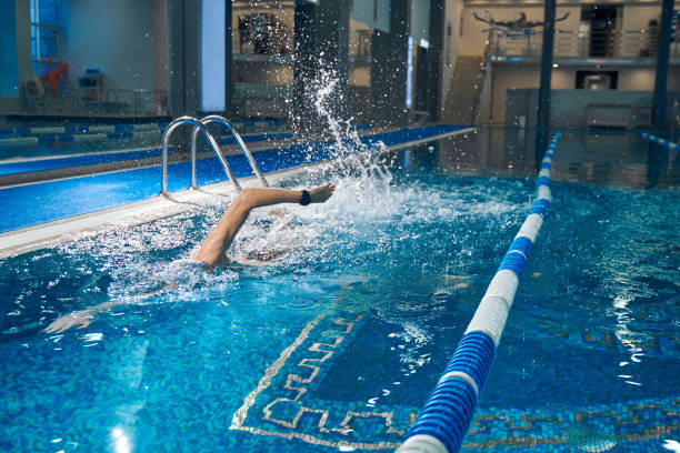 istock Male actively swimming in pool during workout 1388647254