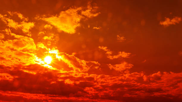 istock orange sky Clouds moving away rolling colorful sunset light dramatic clouds 1388647317