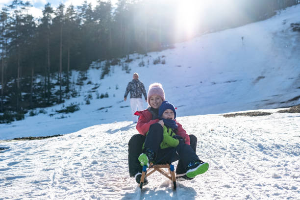 istock Boy and girl enjoys sledding 1388647334