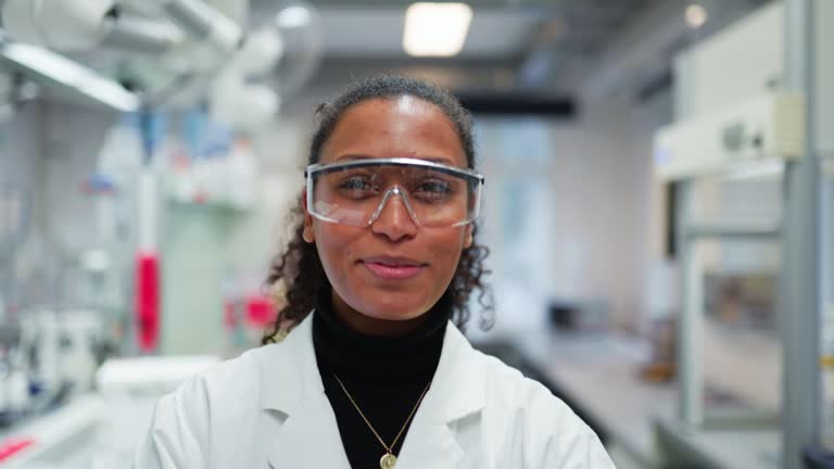 Portrait of young female scientist standing in her lab