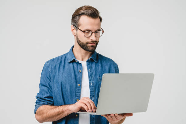 istock Successful caucasian young freelancer student using laptop for online remote work, watching webinars, e-learning, e-banking isolated in white background 1388649905