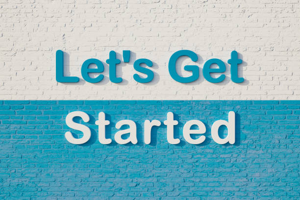 istock Let's get started. Colored capital letters against a white and blue brick wall. 1388650897