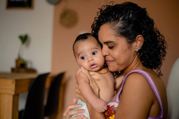 istock Mother caressing the baby on her lap. 1388653099