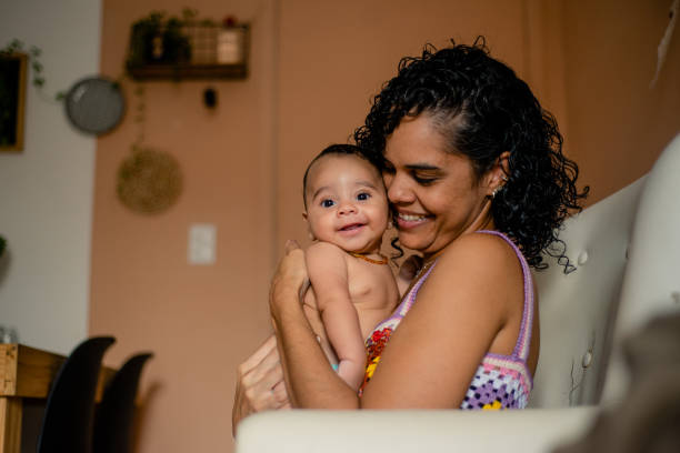 istock Baby smiling and happy on mother's lap. 1388653145