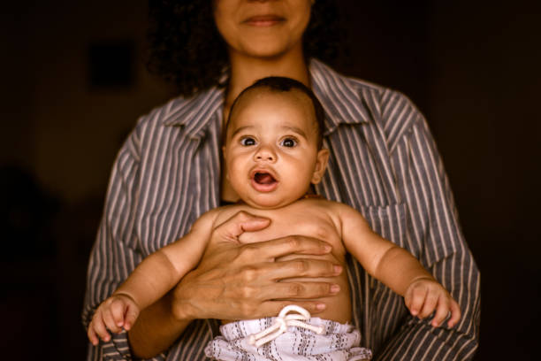 istock Mother with baby on her lap. baby looking. expression 1388653345