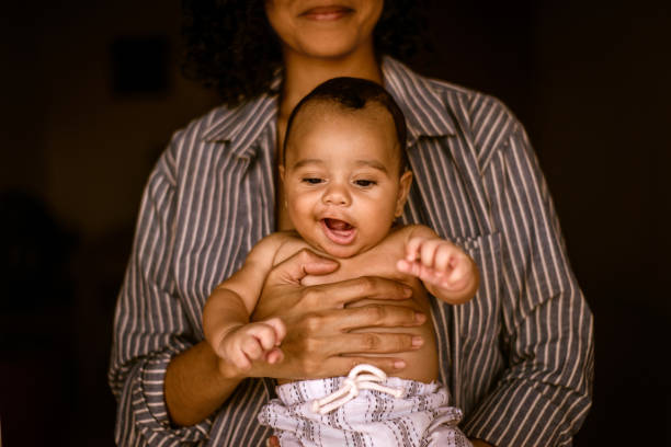 istock Very cute baby on mother's lap. expression 1388653346