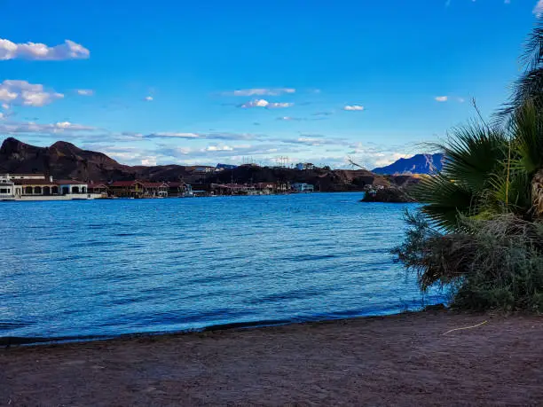 The Colorado River at Emerald Cove in Parker, AZ. A blazing blue shy with a few scattered clouds