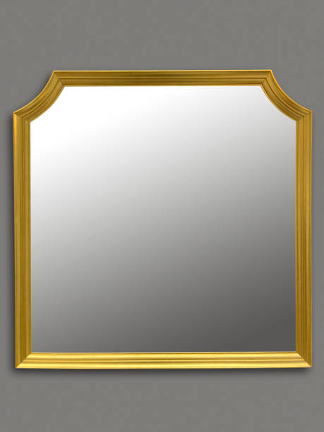 istock Gold frame mirror hanging on the gray wall (Clipping Path) 1388654295