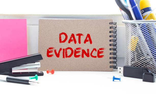 istock DATA EVIDENCE - business concept, text on a notebook with a spring on a pink background 1388654379