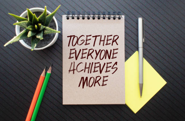 istock Together everyone achieves more phrase written with a typewriter. 1388654384